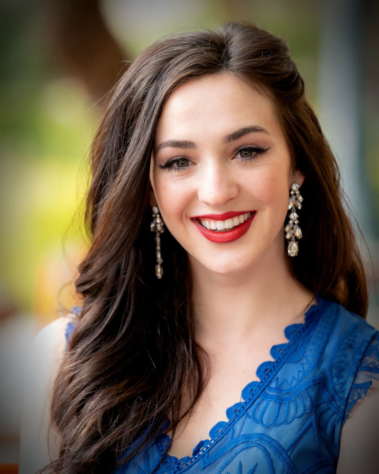 Natural-light portrait of a woman in blue against a softly blurred background